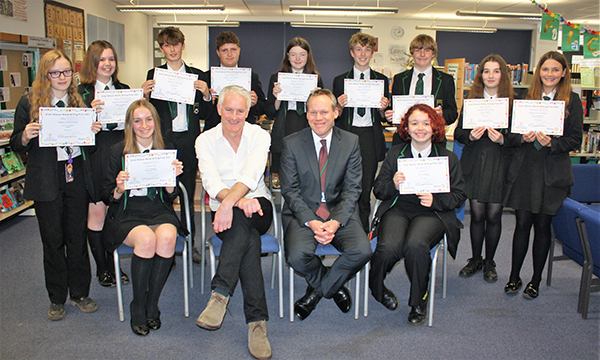 November 2021 – Congratulations to all Helsby High School writing prize winners, who finally got their certificates and book tokens at a special presentation ceremony in school. Judge Tim Firth is pictured here with headmaster Mr M. Hill and all the winning students.